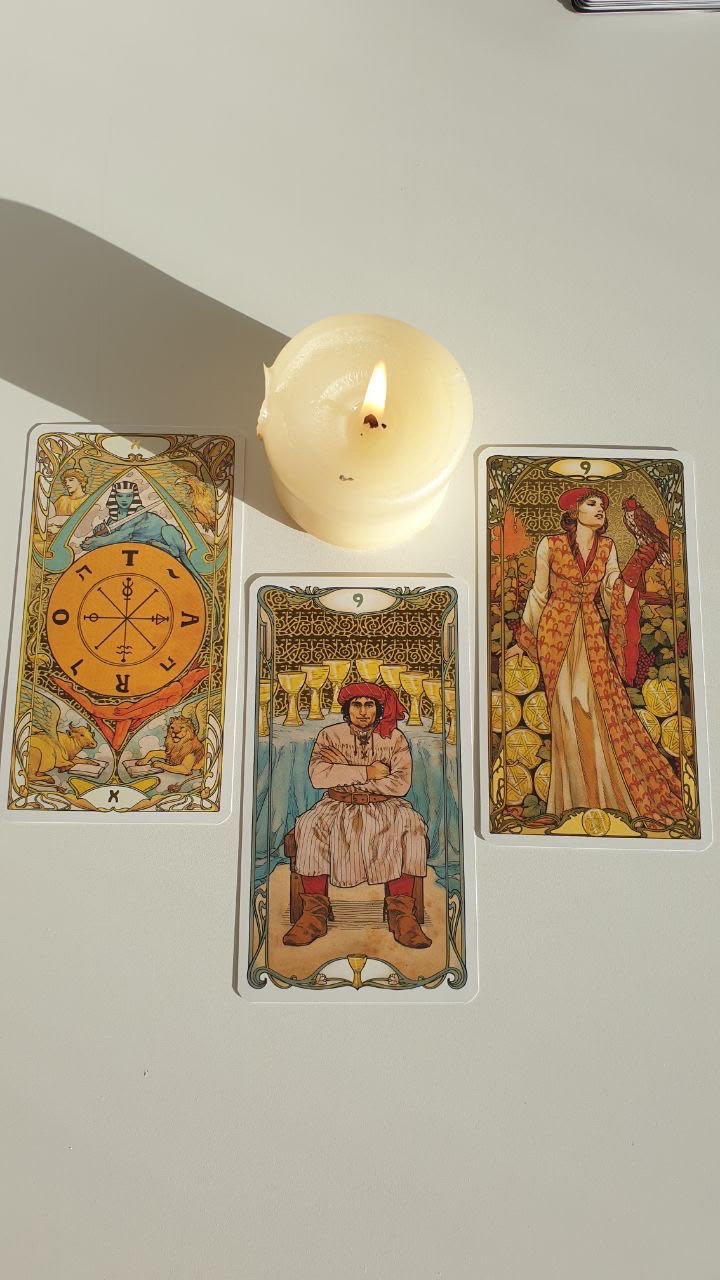 Tarot cards laid out beside a lit candle